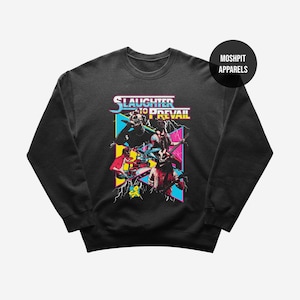 May include: Black crewneck sweatshirt featuring a colorful graphic design. The design includes the text "Slaughter to Prevail" with a band illustration. The sweatshirt has a round neckline and long sleeves. The brand logo "Moshpit Apparels" is on the upper right.