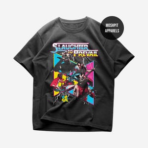 May include: Black t-shirt featuring a graphic design with the text "SLAUGHTER TO PREVAIL" in a colorful, retro style. The design includes illustrations of band members and lightning bolts. The shirt has a crew neck and short sleeves.