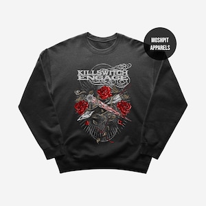 May include: Dark gray sweatshirt featuring a graphic design with the text "KILLSWITCH ENGAGE". The design includes red roses, a dagger, and a circular pattern. The brand name "MOSHPIT APPARELS" is also visible.