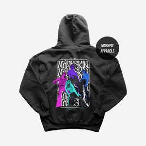 May include: A black hoodie featuring a graphic of a band in vibrant colors. The design includes the band's name and the text "EST. 2016" in a white rectangular frame. A circular logo with "MOSHPIT APPARELS" is on the upper right.