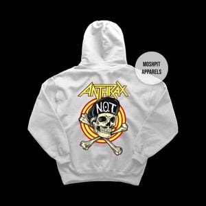 May include: White hoodie with a graphic on the back. The graphic features a skull wearing a hat with the text "N.O.T." and crossed bones. The word "ANTHRAX" is above the skull in yellow. The hoodie has a hood and long sleeves.