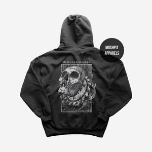 May include: Black hooded sweatshirt featuring a detailed skull graphic with the text "WHITECHAPEL" in a rectangular frame. The design is in black and white. The brand name "MOSHPIT APPARELS" is printed on the upper right side.