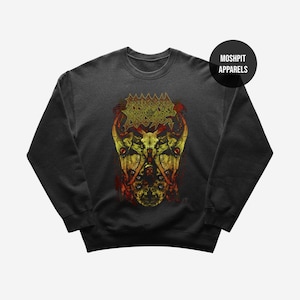May include: Dark grey sweatshirt with a yellow and red graphic design. The graphic features a skull-like image with detailed elements and text at the top. The sweatshirt has a crew neck and long sleeves. The brand name "MOSHPIT APPARELS" is printed on a black circle.
