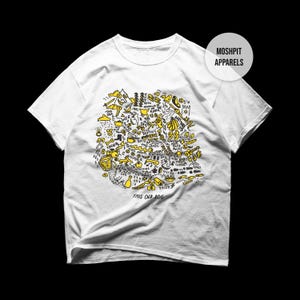 May include: White t-shirt with a yellow and black doodle design. The design includes various illustrations and the text "THIS OLD DOG" at the bottom. The shirt has a crew neck and short sleeves. The brand name "MOSHPIT APPARELS" is on the upper right.
