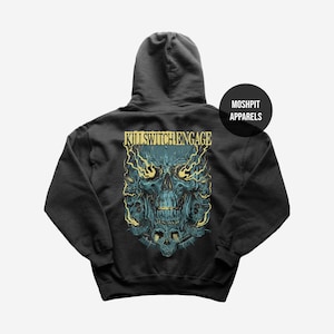 May include: Dark gray hoodie featuring a teal skull graphic with yellow lightning bolts and the text "KILLSWITCHENGAGE". The hoodie also has the text "MOSHPIT APPARELS" on the upper right.