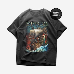 May include: Dark gray t-shirt featuring a detailed graphic of a ship at sea with the word "EPICA" in gold lettering. The design includes a mermaid and a stormy sea. The brand name "MOSHPIT APPARELS" is also visible.