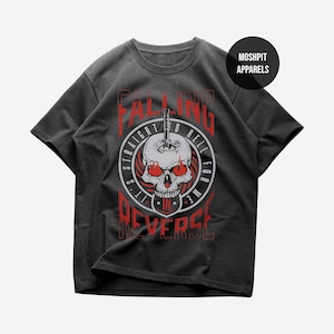 May include: Dark grey t-shirt with a skull graphic, red eyes, and a knife through the head. The text "FALLING STRAIGHT TO HELL FOR ME IN REVERSE" is printed in red and white.