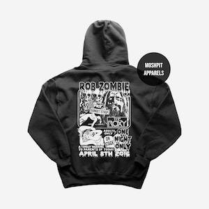 May include: Black hoodie featuring a graphic of Rob Zombie's concert at The Roxy on April 8th, 2016. The design includes the text "RIOT ON SUNSET STRIP" and "ONE NIGHT ONLY". The hoodie has a hood and a "MOSHPIT APPARELS" logo.