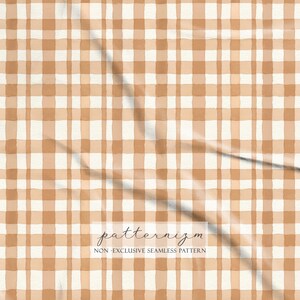May include: A seamless plaid pattern in tan and cream, resembling a watercolour painting. The image includes the text "patternizm" and "NON-EXCLUSIVE SEAMLESS PATTERN". Ideal for fabric or wallpaper, the design has a rustic, hand-painted feel.