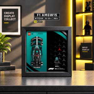 May include: A black framed display featuring a LEGO Mercedes-AMG Petronas F1 W15 race car model and a matching driver minifigure. The background includes the Mercedes logo pattern, the text F1 AMGW15 #77244 25 x 25 cm 300 DPI, and THE BLOCK.