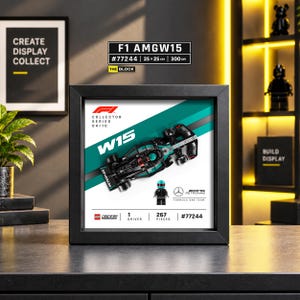 May include: A black framed display featuring a LEGO Speed Champions Mercedes-AMG F1 W15 race car model and a driver minifigure. The white background includes the text F1 Collector Series 04/10, W15, Mercedes-AMG Petronas Formula One Team, and #77244.