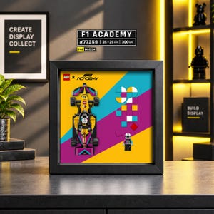 May include: A black framed display featuring a LEGO F1 Academy race car and a driver minifigure on a yellow, teal, and magenta background. The artwork includes the LEGO and F1 Academy logos, with a geometric pattern of squares and circles.