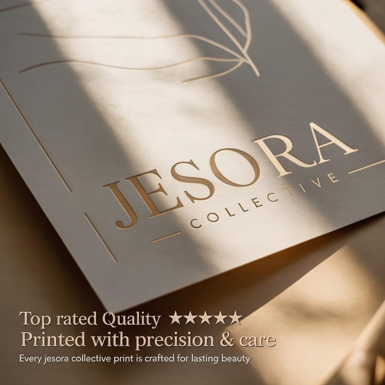 May include: A close-up of a beige print with the gold text "JESORA COLLECTIVE". The print has a leaf design and text that reads "Top rated Quality" and "Printed with precision & care".