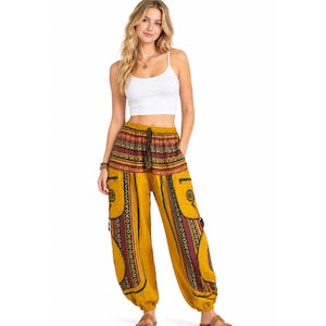May include: A white sleeveless crop top paired with mustard yellow harem trousers featuring a wide waistband with a maroon and black geometric pattern, vertical side stripes, and spiral motifs on the pockets with an elasticated drawstring waist.