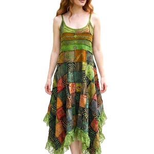 May include: A sleeveless midi dress featuring a patchwork design with various green, orange, and brown fabric panels. The dress has a scoop neckline, thin spaghetti straps, and a hemline finished with a light green lace trim and pointed edges.
