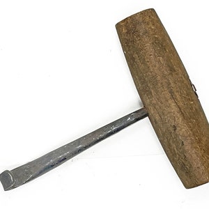 May include: A vintage wooden handled metal hook tool. The hook is made of metal and has a long, curved handle. The handle is made of wood and is brown in color.