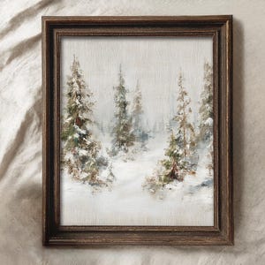 May include: A framed winter landscape painting. The artwork depicts snow-covered evergreen trees in a forest setting. The painting has a muted color palette with shades of white, green, and brown. The frame is a dark brown color.