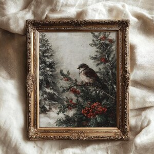 May include: A framed vintage painting of a bird perched on a branch with red berries. The artwork is set against a snowy backdrop with evergreen trees. The ornate gold frame adds a classic touch to the winter scene.
