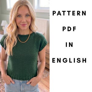 May include: A woman wearing a dark green knit top and a gold chain necklace. The text "PATTERN PDF IN ENGLISH" is displayed in black, indicating a pattern available in English.