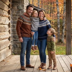 May include: A family wearing knit sweaters with Fair Isle patterns. The adult on the left wears a brown sweater with blue jeans. The child wears a gray sweater with blue jeans. The adult on the right wears a navy sweater with blue jeans.