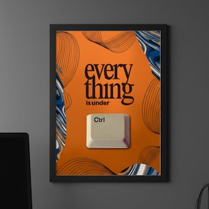 May include: Framed art print with an orange background and the words "everything is under" in black. A large Ctrl key is centered below the text. The artwork features abstract blue and white wave-like designs and is framed in black.