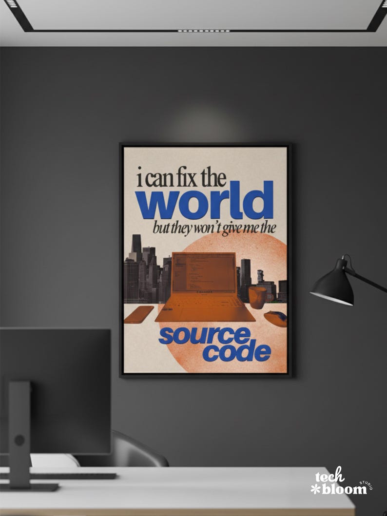 May include: A framed poster with the text "i can fix the world but they won't give me the source code." The image features a laptop, cityscape, and a circular design in orange and blue tones. The poster is in a black frame.