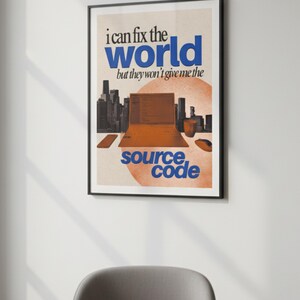 May include: A framed poster with the text "i can fix the world but they won't give me the source code." The image features a laptop, cityscape, and other tech-related elements in a retro style. The poster is in a black frame.