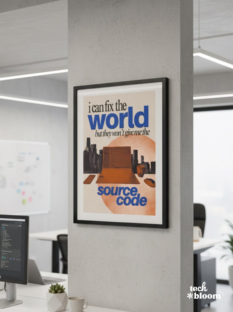 May include: A framed poster with the text "I can fix the world but they won't give me the source code." The poster features a cityscape, a laptop graphic, and orange and blue text. The poster is hanging on a white wall.