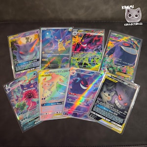 May include: A collection of Pokemon trading cards featuring Gengar and other characters. The cards have various holographic and colorful designs, with text including "Horror House GX" and "Gengar & Mimikyu GX". The cards are in protective sleeves.