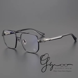 May include: Black metal eyeglasses with a double bridge and square lenses. The temples feature decorative silver accents. The glasses have a modern, sophisticated design. The logo "G Spectrum" is in the bottom right corner.