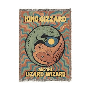 May include: Woven throw blanket featuring a psychedelic design with the text "KING GIZZARD" and "AND THE LIZARD WIZARD". The design includes two lizards in a yin-yang style, with a swirling pattern in shades of green, orange, and blue.
