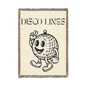 May include: Cream-colored woven throw blanket with a black and white cartoon disco ball character and the words "DISCO LINES" in black. The blanket has a fringed edge.