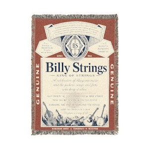 May include: A rectangular woven throw blanket featuring a rust-colored border and a cream-colored center. The design includes the text Billy Strings, King of Strings, and various musical illustrations, including a banjo, guitar, and upright bass.