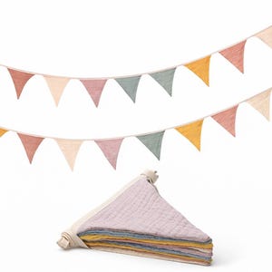 May include: A set of three ceramic mugs with a speckled, matte finish. The mugs are in shades of cream, light gray, and dark gray. Each mug has a simple, minimalist design and a rounded handle.