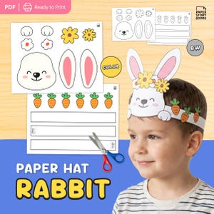 Puede incluir: Un kit de manualidades de papel para un sombrero de conejo. El kit incluye una cara de conejo blanca, orejas forradas de rosa, flores amarillas y zanahorias naranjas. El texto "PAPER HAT RABBIT" se muestra en amarillo y negro.