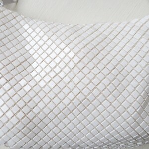 May include: A white mesh handbag with a square pattern.