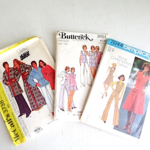 May include: Three vintage sewing pattern envelopes including a yellow-bordered McCall's 3738, a white Butterick 3054, and a blue-bordered Simplicity 7044. Each envelope features illustrations of clothing designs, model numbers, and sizing information printed on the front.