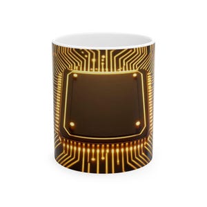 May include: White ceramic coffee mug featuring a detailed, glowing gold circuit board design. The design wraps around the mug, with a prominent dark brown rectangular shape in the center. The mug is a standard size for hot beverages.
