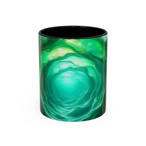 May include: A ceramic coffee mug with a black interior and a vibrant green and teal swirling design. The design resembles an abstract underwater scene or a tunnel, with lighter green and yellow highlights. The mug is cylindrical.