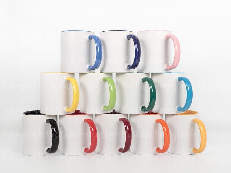 May include: A stack of white ceramic mugs with colored handles and rims. The mugs have handles in blue, pink, green, yellow, orange, black, and red. The rims are also colored, with some having a matching interior.