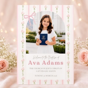 May include: Baptism announcement featuring a young girl holding a blue book, framed by a pink and white floral design. The text reads "Welcome to the Baptism of Ava Adams" with the date and church information.