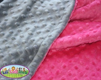 May include: A soft, gray and pink minky fabric with a textured, dotted pattern. The fabric is perfect for baby blankets, throws, and other soft goods.