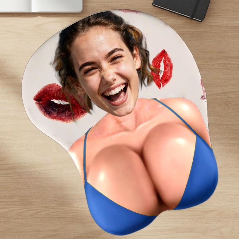 May include: Ergonomic mousepad featuring a smiling woman's face and a blue bikini top design. The mousepad has a wrist rest for comfort and includes red lipstick kiss marks.