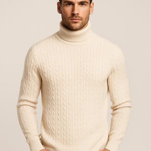 May include: Cream-colored cable knit turtleneck sweater. The sweater has a ribbed turtleneck collar and cuffs. The cable knit pattern is vertically aligned. The sweater is made of a soft, warm material.