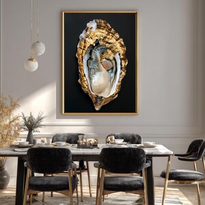 May include: A framed artwork featuring a detailed oyster shell with gold accents against a black background. The oyster is open, revealing a pearlescent interior. The artwork is displayed above a dining table with black chairs and a marble top.