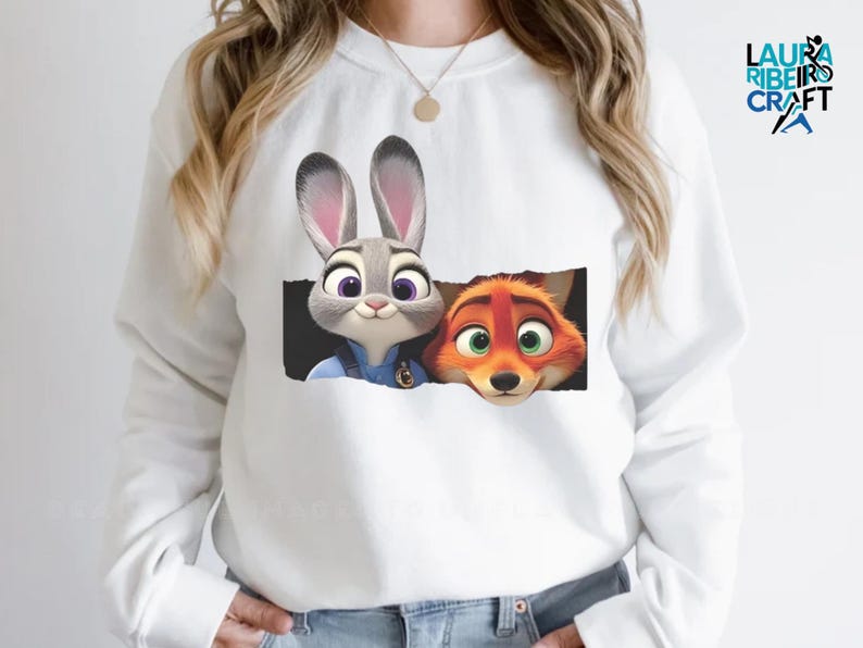 A white long-sleeved shirt with a graphic design featuring two cartoon animal characters, a rabbit and a fox, peeking out from a black frame.