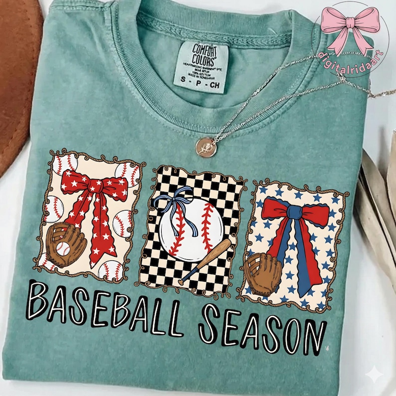May include: A teal Comfort Colors t-shirt with a baseball theme. The shirt features three framed baseball designs with a baseball, glove, and bow. The words "BASEBALL SEASON" are printed in black script.
