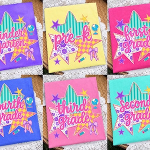 May include: A collection of six t-shirts in purple, yellow, pink, blue, light pink, and teal. Each shirt features a graphic of two overlapping stars with patterns, a globe, a pencil, a bow, and text indicating school grade levels.