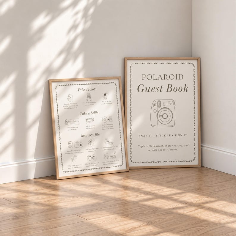 May include: Two framed signs with light wood frames. The right sign reads Polaroid Guest Book with a camera illustration. The left sign provides instructions for taking photos, selfies, and loading film with small icons and text for each step.