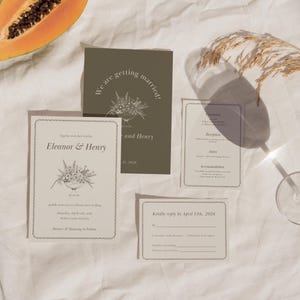 May include: A collection of wedding stationery, including invitations and reply cards. The invitations feature floral illustrations and the names "Eleanor & Henry." The cards are in shades of beige and olive green, with decorative borders.